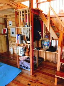 a room with wooden floors and a room with a bed at Đà Lạt Củi Homestay in Da Lat