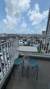 a white table and two chairs on a balcony at Vida View Apartment by Vida Connect in Makassar