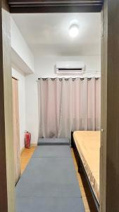 an empty room with curtains and a mattress at Netflix & Chill at Pablo's Homestay-Grace Residences Tower 4 in Manila +19 photos