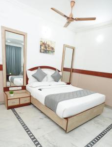 a bedroom with a large bed and a mirror at Hotel The Black Diamond in Bangalore