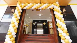 a balloon archway in front of a hallway at Hotel The Black Diamond in Bangalore