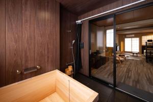 a room with a shower with a glass wall at Ryokan Suzuri 旅館 すずり in Tokyo +56 photos