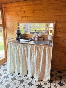 a kitchen with a sink and a window at Eudaimonia Wooden Suites Nafplio Kandia in Kandia