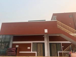 a house with a staircase on the side of it at Smarami homestay in Hospet