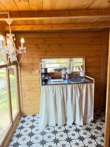 a kitchen in a log cabin with a sink at Eudaimonia Wooden Suites Nafplio Kandia in Kandia