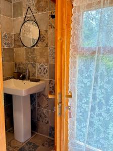 a bathroom with a sink and a mirror at Eudaimonia Wooden Suites Nafplio Kandia in Kandia