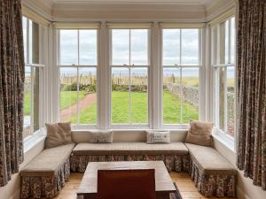 a window seat in a living room with a view at Ruddon Grange in Elie