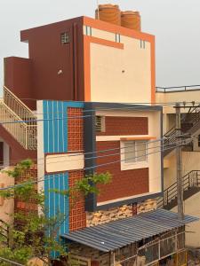 a building with stairs in front of it at Smarami homestay in Hospet