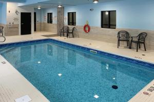 a large swimming pool with chairs and a table at Quality Inn in Ottawa