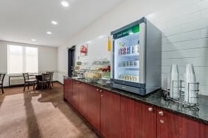 a restaurant with a counter with a refrigerator at Quality Inn in Ottawa