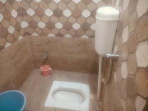a small bathroom with a toilet in a room at Hotel shyama inn in Lucknow