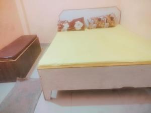 a bed in a room with a wooden bed frame at Hotel shyama inn in Lucknow