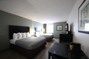 a hotel room with a bed and a desk at Quality Inn & Suites Mattoon South in Mattoon +22 photos