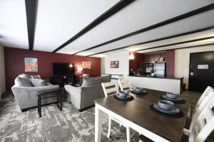 a living room with a table and chairs and a kitchen at Quality Inn & Suites Mattoon South in Mattoon