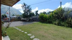 a view of a yard with mountains in the background at Villa Bella Sembalun in Sembalun Lawang +11 photos