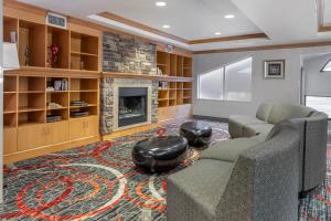 a living room with a couch and a fireplace at Comfort Suites Boise West Meridian in Meridian