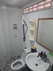 a bathroom with a white toilet and a sink at Funky Crab The River in Krabi