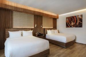 Llit o llits en una habitació de Radisson Puebla Angelopolis