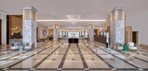 a lobby with a large lobby with chairs and tables at Sariya Hotel in Yanbu +195 photos