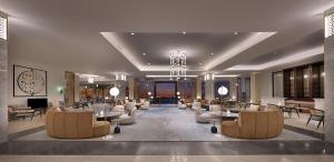 a lobby with chairs and tables in a building at Sariya Hotel in Yanbu