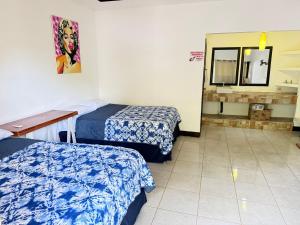 a hotel room with two beds and a mirror at Casa villa del mar 2 in Miramar