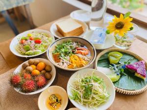 a table topped with plates of food on a table at Nong Lam Ecolodge in Linh Xuân Thôn