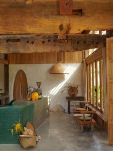 a living room with wooden ceilings and a table at Nong Lam Ecolodge in Linh Xuân Thôn