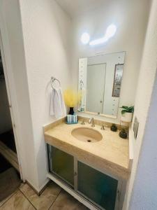 a bathroom with a sink and a mirror at Suite Acapulco vista al mar in Acapulco