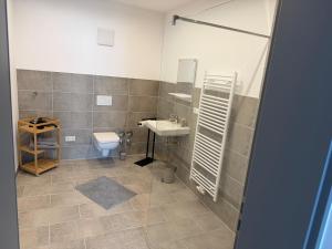 a bathroom with a sink and a toilet at Ferienwohnung -Alte Backstube- in Hadamar +7 photos