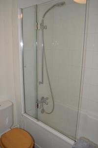 a bathroom with a glass shower with a toilet at Crockers Farm in Dorking