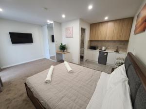 a large room with a bed and a kitchen at Harbour Retreat in Hayborough