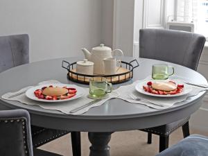 a table with two plates of food on top of it at Lovely Little Let in Birnam