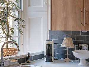 a kitchen with a coffee maker on the counter at Lovely Little Let in Birnam +9 photos
