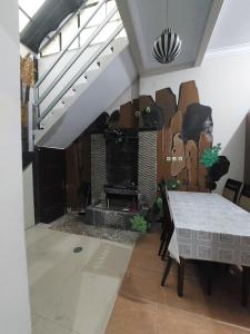 a living room with a table and a fireplace at Clara Guest House in Seturan +3 photos