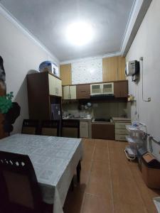 a small kitchen with a table in a room at Clara Guest House in Seturan