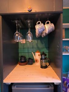 a shelf in a kitchen with pots and pans at Dora's 5 Berth Static with stunning views in Saint Martin