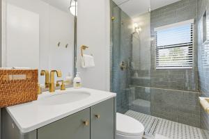 a bathroom with a sink and a toilet and a shower at Jefferson Avenue Suites in Miami Beach