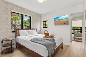 a bedroom with a large bed and a window at Jefferson Avenue Suites in Miami Beach