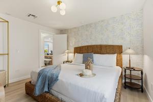 a bedroom with a bed with a white bedspread at Jefferson Avenue Suites in Miami Beach