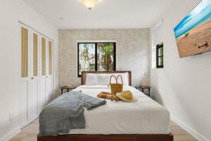a bedroom with a bed with a hat on it at Jefferson Avenue Suites in Miami Beach