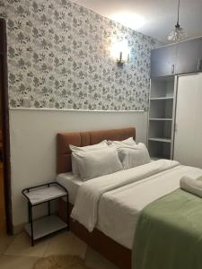 a bedroom with a bed and a patterned wall at Serene Sidai in Nairobi