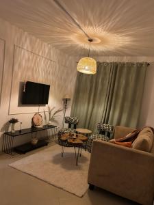 a living room with a couch and a tv at Serene Sidai in Nairobi