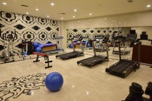 a gym with a bunch of exercise equipment in a room at Dogramaci Hotel City in Tosya