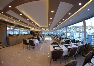 a dining room with tables and chairs in a restaurant at Dogramaci Hotel City in Tosya