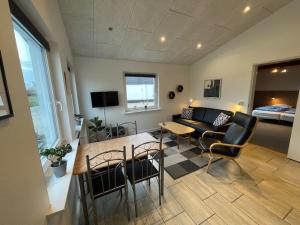 a living room with a couch and a table and chairs at Marskferie Tønder in Tønder