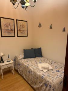 a bedroom with a bed and a side table at Vida Entre Balcones in Combarro +3 photos