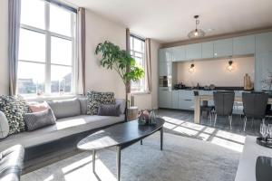 a living room with a couch and a table at The Carriage House - Historic 3-Bedroom Apartment near Utrecht - Huize de Lekpoort Vianen in Vianen