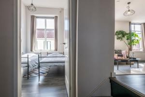 a hallway with a bedroom and a living room at The Carriage House - Historic 3-Bedroom Apartment near Utrecht - Huize de Lekpoort Vianen in Vianen