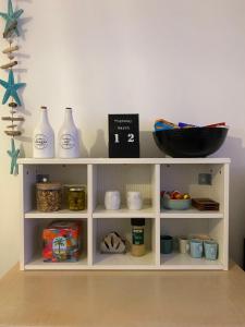 a shelf with vases and other items on it at Risan Chill in Eilat