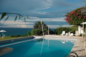 a swimming pool with a view of the ocean at Palalong Views in Dumanjug